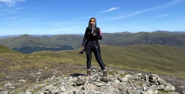 zarah mahmood mbe standing on a high point on a mountainous region